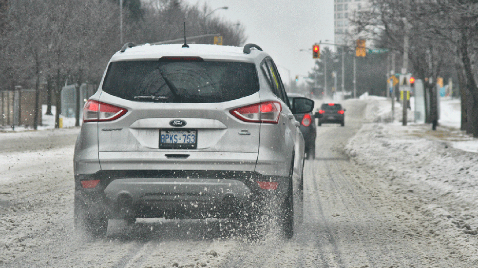 A Ford car driving in the snow